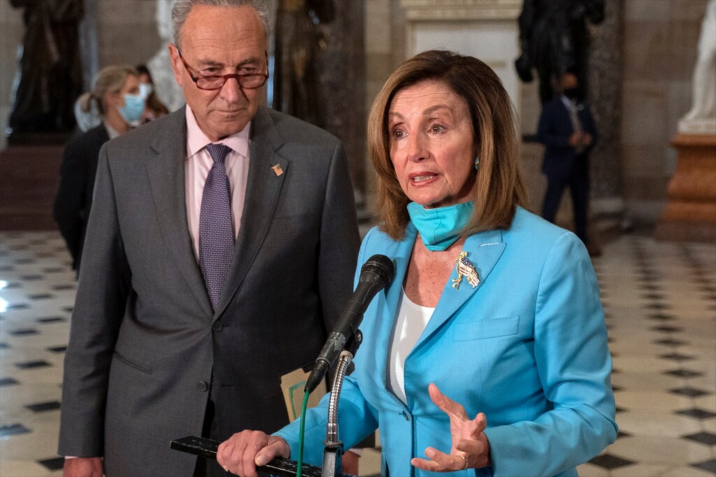 House Speaker Nancy Pelosi of Calif., joined by Senate Minority Leader Sen. Chuck Schumer of N.Y., speaks to media on Capitol Hill in Washington, Wednesday, Aug. 5, 2020. Some clarity is beginning to emerge from the bipartisan Washington talks on a huge COVID-19 response bill. An exchange of offers and meeting devoted to the Postal Service on Wednesday indicates the White House is moving slightly in House Speaker Nancy Pelosi's direction on issues like aid to states and local governments and unemployment insurance benefits. But the negotiations have a long ways to go. (AP Photo/Carolyn Kaster)