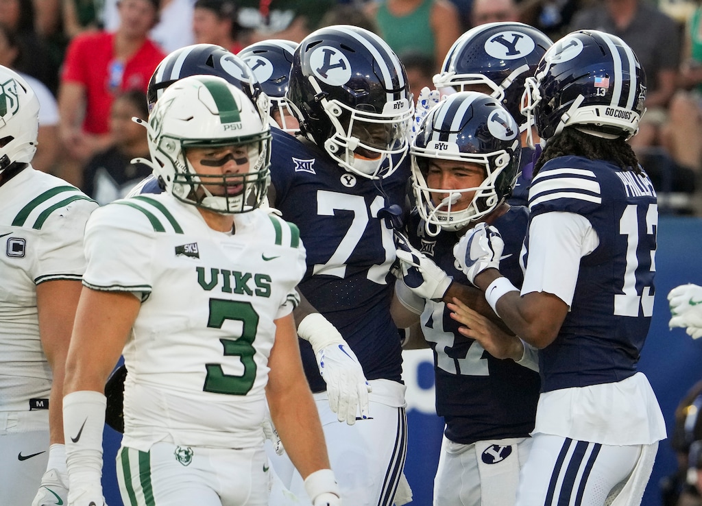 (Bethany Baker | The Salt Lake Tribune) Brigham Young Cougars quarterback Bear Bachmeier (47), center, celebrates with teammates after scoring a touchdown during the game between the Brigham Young Cougars and the Portland State Vikings in Provo on Saturday, Aug. 30, 2025.
