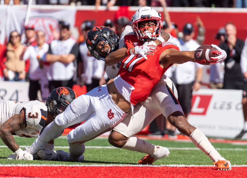 (Rick Egan | The Salt Lake Tribune)  Utah Utes wide receiver Devaughn Vele (17) stretches over the line for a touchdown, as Oregon State Beavers defensive back Alex Austin (5) tries to hold him back, in PAC 12 football action between the Utah Utes and the Oregon State Beavers, at Rice-Eccles Stadium in Salt Lake City, on Saturday, Oct. 1, 2022.