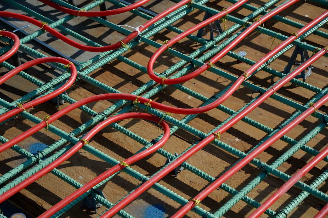 (Francisco Kjolseth  |  The Salt Lake Tribune) UDOT gives a tour of the state’s new longest pedestrian bridge on Thursday, August 20, 2020, connecting Utah Valley University in Orem to student housing and the community on the West side of I-15. Crews are finishing up an extensive hydronic heating system that will pump warm water to keep the bridge clear of snow in the winters, as it gets ready to pour concrete for the walking surface. UDOT will close I-15 in both directions this weekend for work on the nearly 1,000 foot bridge that is 15 feet wide to accommodate pedestrians, cyclists and scooters. Elevators and stairs with small ramps to push up bicycles will be on each side of the bridge.