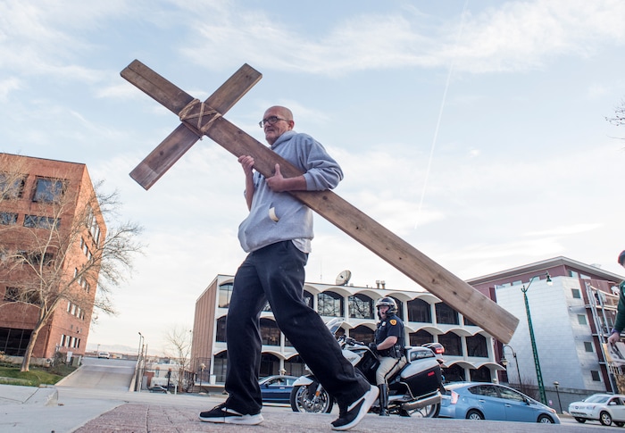 (Rick Egan  |  The Salt Lake Tribune)     Alex Burey, from Sunset, carries the cross as clergy and members of Christian denominations participate in the annual Good Friday procession through downtown Salt Lake City, Friday, March 30, 2018. The procession commemorating Christ's path to crucifixion has been a tradition of the Salt Lake Council of Churches since 1988. 


