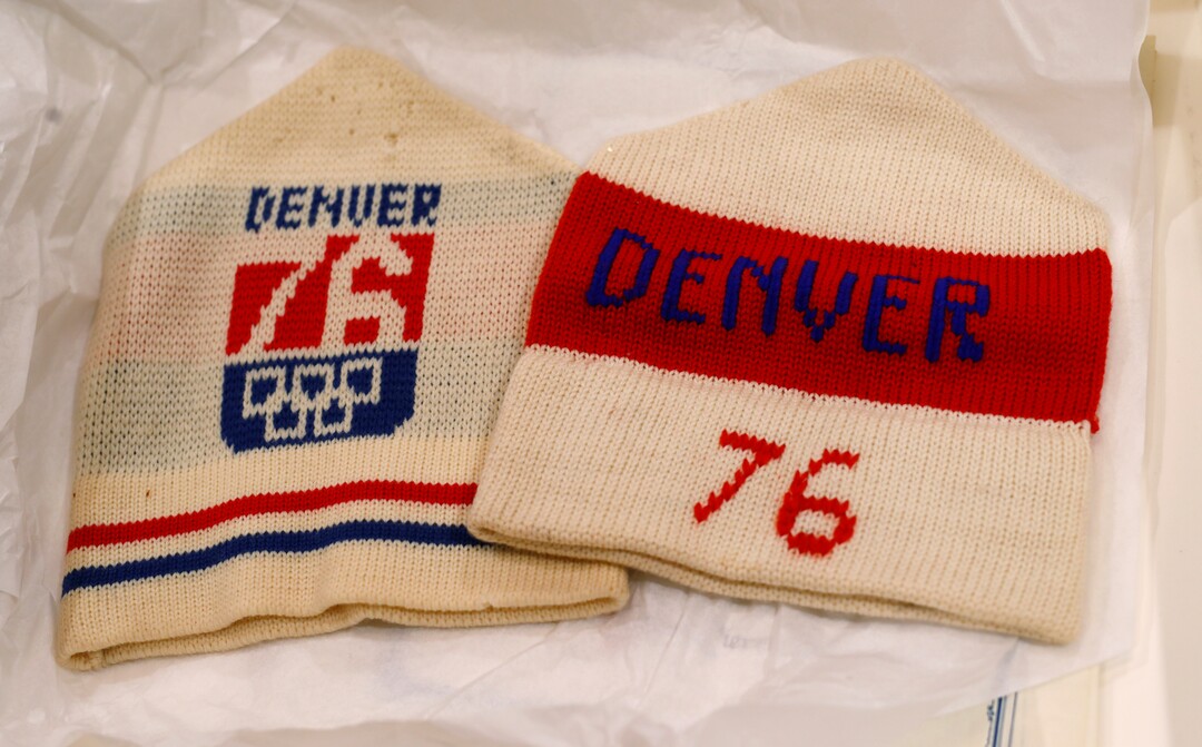 In this Feb. 1, 2018, photo, stocking hats used in Colorado's effort to secure an Olympic bid in 1976 are part of the memorabilia collection of the Denver Public Library in Denver. Over 40 years after becoming the first city to walk away from an Olympic bid, Denver is considering whether to try to again to host the Winter Games. (AP Photo/David Zalubowski)