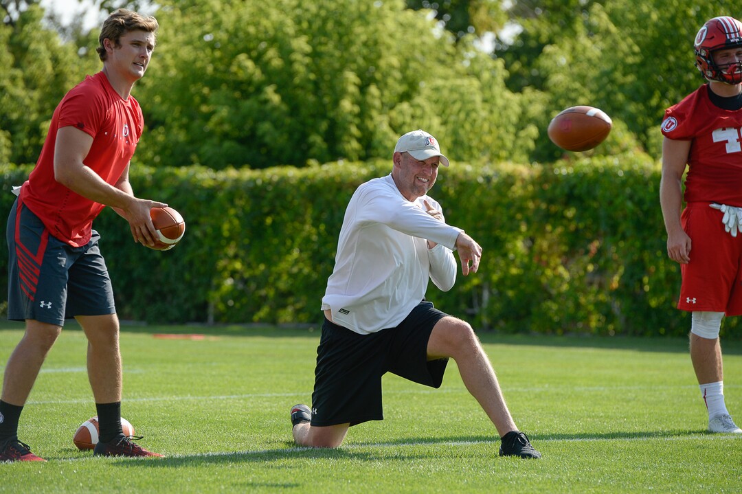 (Francisco Kjolseth  |  The Salt Lake Tribune)  Offensive coordinator Troy Taylor works his arm and his players as the Utah football team takes to the practice field for day one of the season on Wed. Aug. 1, 2018.