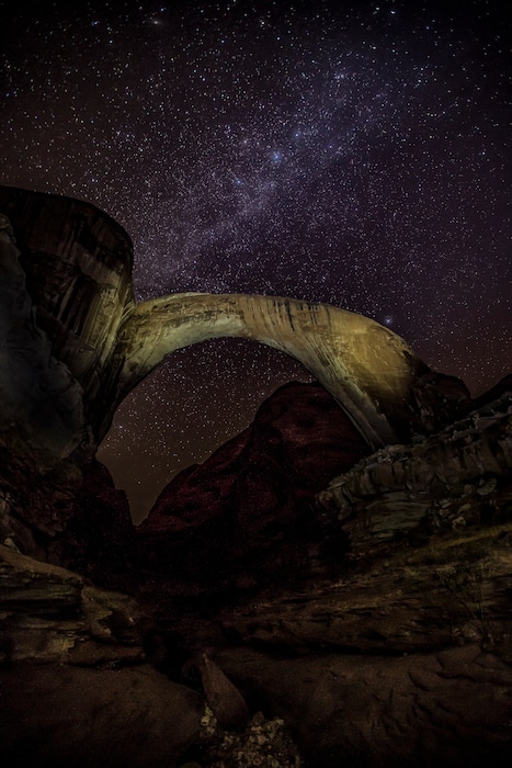 (Brent and Dawn Davis | Courtesy of the National Park Service) Rainbow Bridge, as seen at night. The national monument has been selected as an international dark-sky sanctuary.