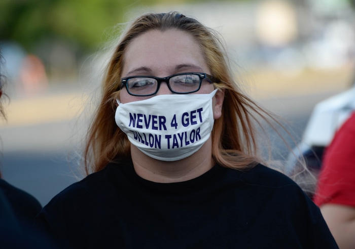 (Francisco Kjolseth  |  The Salt Lake Tribune) Natasha Clausen, joins a vigil on the six-year anniversary of Dillon Taylor’s death by the murals of those people killed by police near 800 South and 300 West in Salt Lake City on Tuesday, August 11, 2020. Multiple families who’s loved one’s are depicted on the walls joined the vigil as they moved from portrait to portrait to remember them.