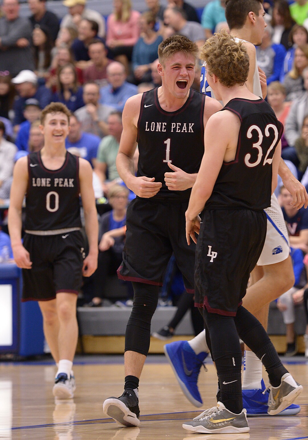(Leah Hogsten  |  The Salt Lake Tribune) Lone Peak's  Taylor Madsen celebrates back-to-back 3-pointers with Max Brenchley (1). Lone Peak High School boys' basketball team defeated Pleasant Grove High School 65-61 during their game Friday, January 26, 2018 in Pleasant Grove. 