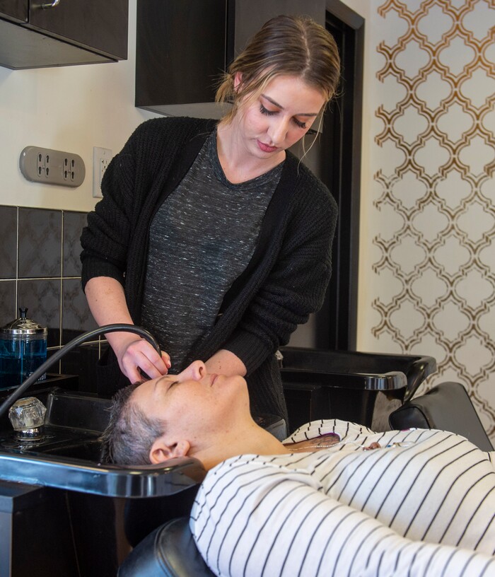 (Rick Egan  |  The Salt Lake Tribune)     Ellen Stephenson rinces Donna May's hair  at Mid City Salon, Saturday, March 21, 2020.