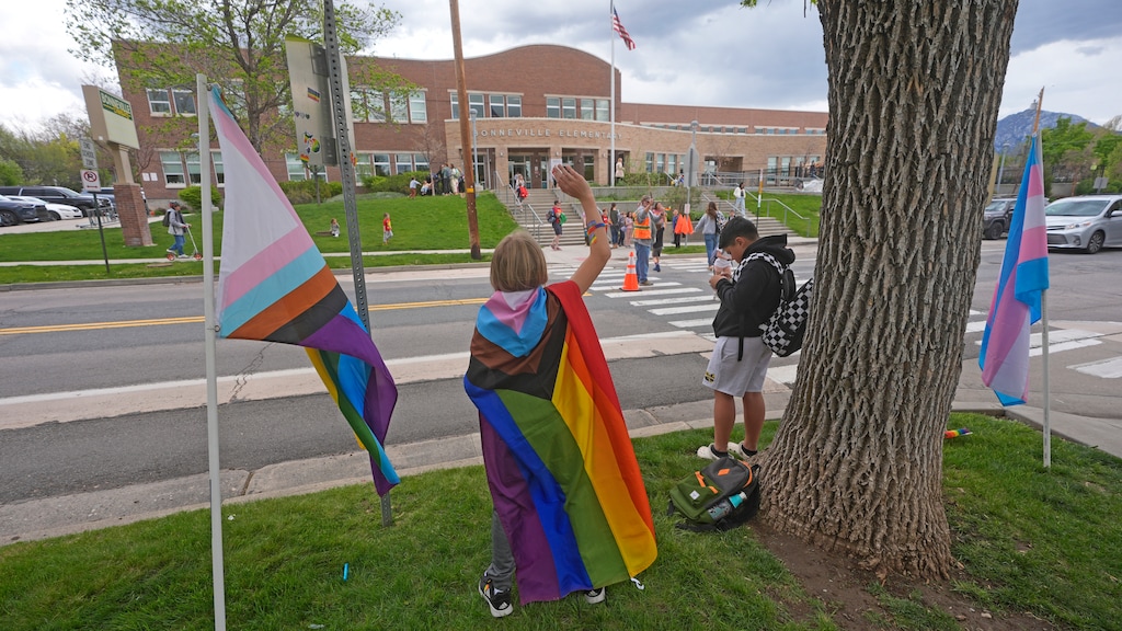 (Rick Bowmer | AP) Bonneville Elementary School 5th grader Graham Beeton, waves to fellow students during a block party supporting trans and non binary students and staff Monday, April 29, 2024, in Salt Lake City. Utah will become the latest state to implement restrictions for transgender people using school bathrooms and locker rooms in public schools and government-owned buildings when key components of a law passed by the Republican controlled Legislature take effect May 1.