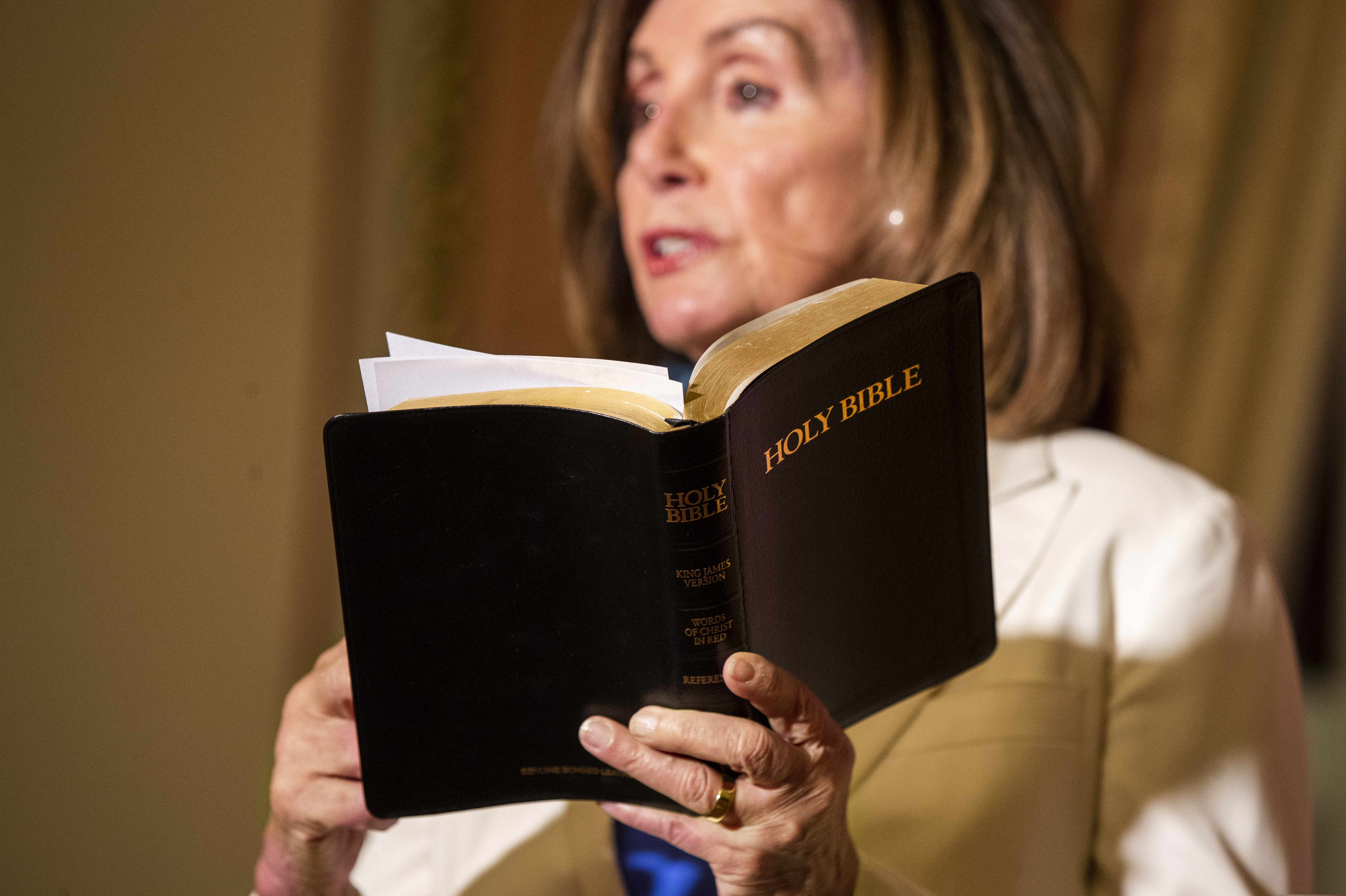 (Manuel Balce Ceneta | AP) Then-House Speaker Nancy Pelosi reads from the Bible at the U.S. Capitol in 2020. A record 80% of U.S. adults say religion’s role in American life is shrinking.