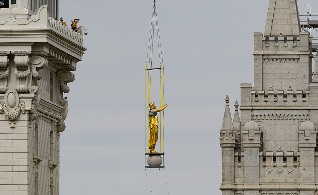 (Francisco Kjolseth  |  The Salt Lake Tribune) Crews work to remove the Angel Moroni statue atop the Salt Lake Temple of The Church of Jesus Christ of Latter-day Saints on Monday, May 18, 2020. The temple closed in December for seismic upgrades and sustained minor damager during the March 18, 2020, magnitude 5.7 earthquake when the trumpet held by the angel fell off and several smaller spire stones were displaced.