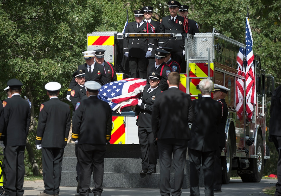 (Rick Egan  |  The Salt Lake Tribune)  The casket carrying Matthew Burchett is unloaded from Draper fire engine 21 at Eastlawn Memorial Hills Cemetery in Provo, Monday, Aug. 20, 2018.