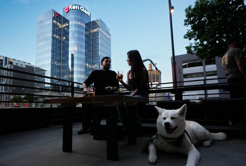 (Francisco Kjolseth | The Salt Lake Tribune) Ashton Aragon and his wife, Elle Aragon, enjoy a drink on the patio of their new downtown Salt Lake City bar named Sayonara, along with their dog Winnie, on Monday, Aug. 14, 2023.