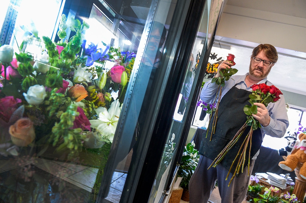 (Leah Hogsten  |  The Salt Lake Tribune) Twigs Flower Co. owner Ray King fills an order of flowers Friday for a wedding. King said the wedding originally was for 350 people, but because of the coronavirus, the invite was cut down to 10 people.