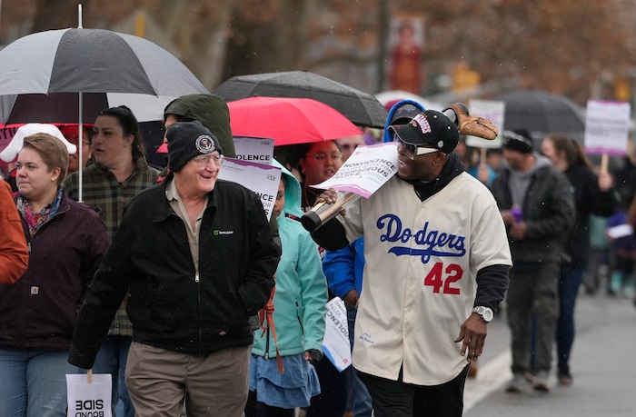(Leah Hogsten | The Salt Lake Tribune) George Zinn, left, and Everett Spencer, walk in the march from East High School to Kingsbury Hall on Monday. To commemorate the legacy and work of Martin Luther King, Jr. and many other activists fighting for racial equality during the Civil Rights movement, the University of Utah's office of Equity, Diversity & Inclusion kicked off MLK Week 2023 with a rally at East High School, followed by a march to Kingsbury Hall, Jan. 16, 2023. 