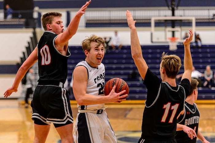 (Trent Nelson | The Salt Lake Tribune)  Corner Canyon's Blake Emery (23) drives between Bountiful's Brig Willard (10) and Bountiful's Garrett Buchanan (11), as Corner Canyon faces Bountiful in the title game of the Corner Canyon Tournament of Champions, high school boys' basketball in Draper, Saturday December 2, 2017.