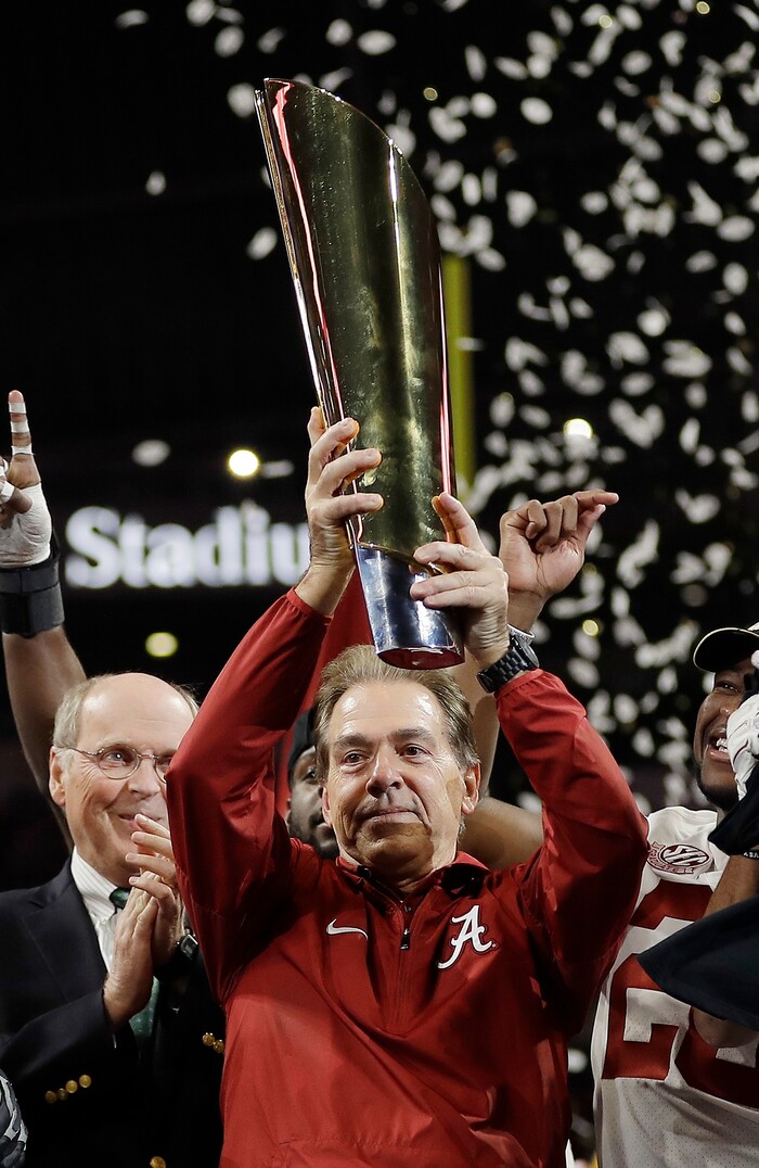 Alabama head coach Nick Saban holds up the championship trophy after overtime of the NCAA college football playoff championship game against Georgia, Monday, Jan. 8, 2018, in Atlanta. Alabama won 26-23. (AP Photo/David J. Phillip)