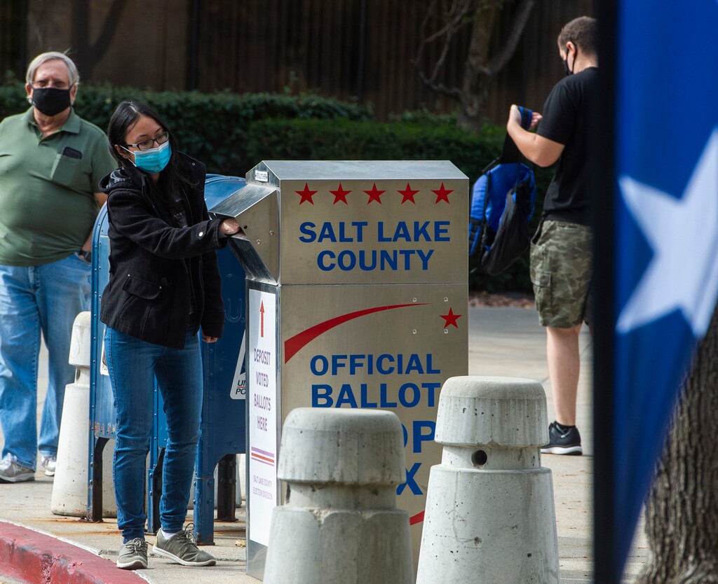 (Rick Egan  |  The Salt Lake Tribune)    Voters drop their ballots in the vote-by-mail ballot drop box at the Salt Lake County Government Center on Monday, Oct. 19, 2020.