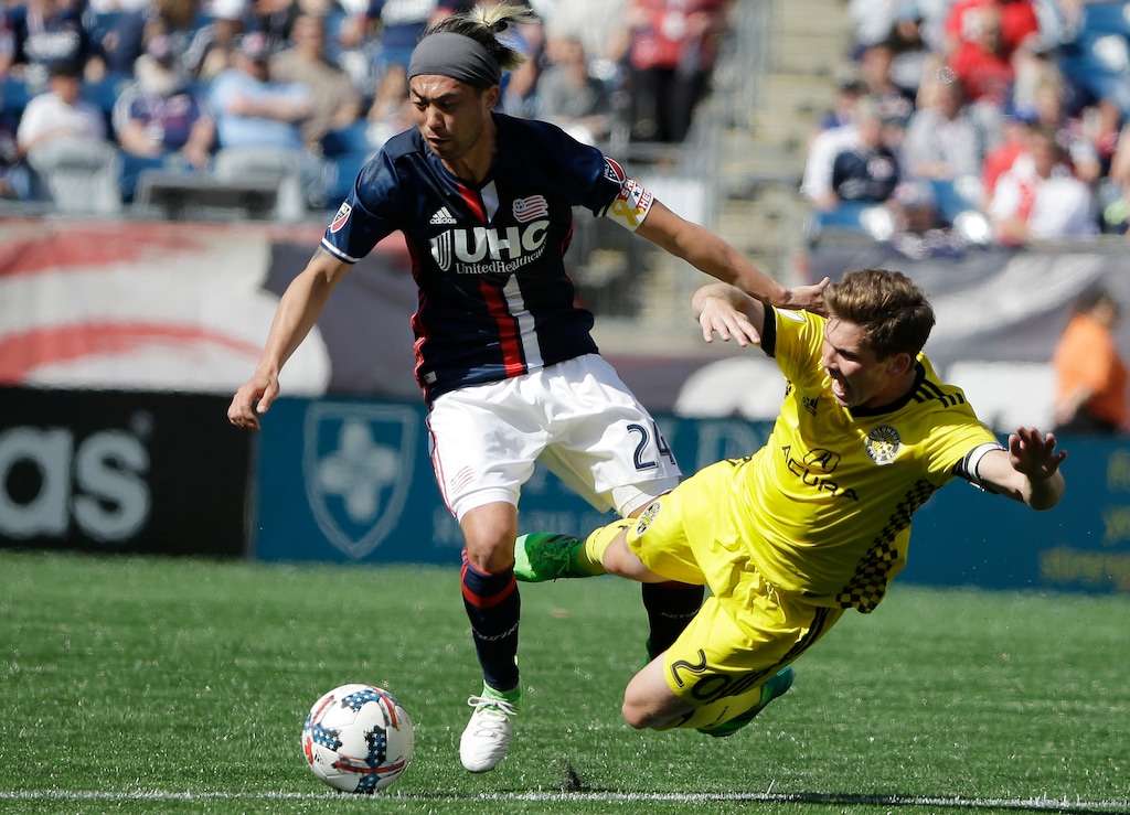 New England Revolution midfielder Lee Nguyen, left, and Columbus Crew midfielder Will Trapp, right, pursue the ball during the second half of an MLS soccer game, Sunday, May 21, 2017, in Foxborough, Mass. The Revolution won 2-1. (AP Photo/Steven Senne)