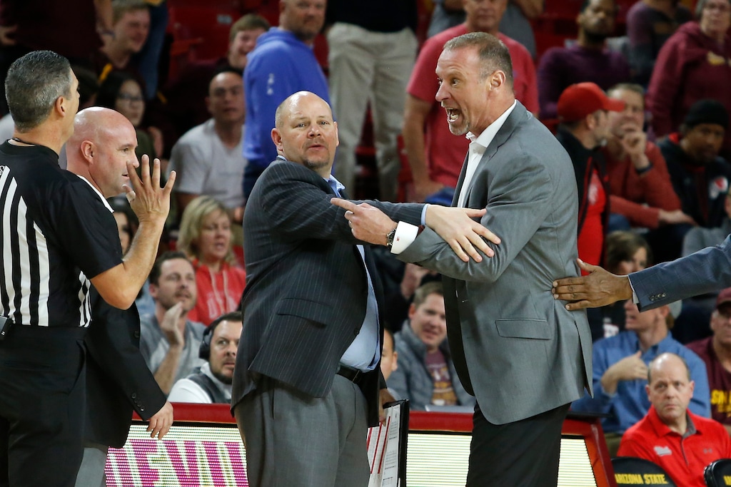 (Ralph Freso | AP) Utah coach Larry Krystkowiak is restrained by an assistant coach as he argues with an official after receiving two technical fouls being ejected during the second half of the team's NCAA college basketball game against Arizona State, Saturday, Jan. 18, 2020, in Tempe, Ariz.