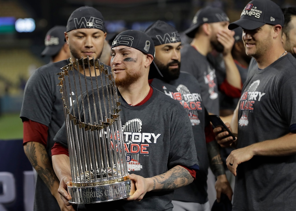 (David J. Phillip | The Associated Press) Boston Red Sox catcher Christian Vazquez holds the championship trophy after Game 5 of baseball's World Series against the Los Angeles Dodgers on Sunday, Oct. 28, 2018, in Los Angeles. The Red Sox won 5-1 to win the series 4 game to 1.