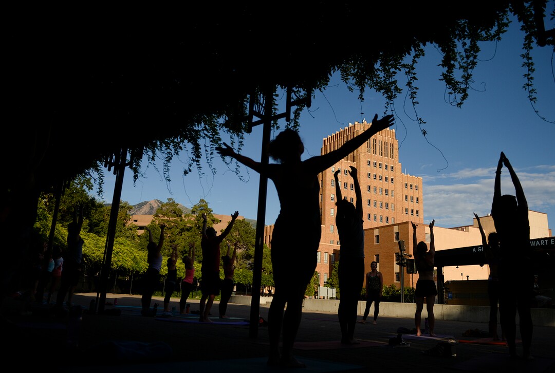 (Leah Hogsten  |  The Salt Lake Tribune) Dozens of yoga enthusiasts filled the Ogden Amphitheater on Thursday, July 25, 2019 during the annual free yoga class sponsored by the Front Yoga Loft and The Front Climbing Club. Nine instructors from the Front Yoga Loft led the crowd as the music of guitarist Julian Alvarez played in the background.