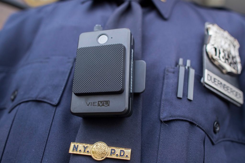 (AP Photo/Mary Altaffer) In this April 27, 2017 file photo, a police officer wears a newly-issued body camera outside in New York. In 2018, the New York City Police Department, the nation’s largest, stopped releasing body camera video after a police union successfully argued in court that they were confidential personnel records. But the department vowed in February 2019 to continue releasing video of officer-involved shootings after an appeals court ruled that the union’s argument “would defeat the purpose of the body-worn-camera program.”