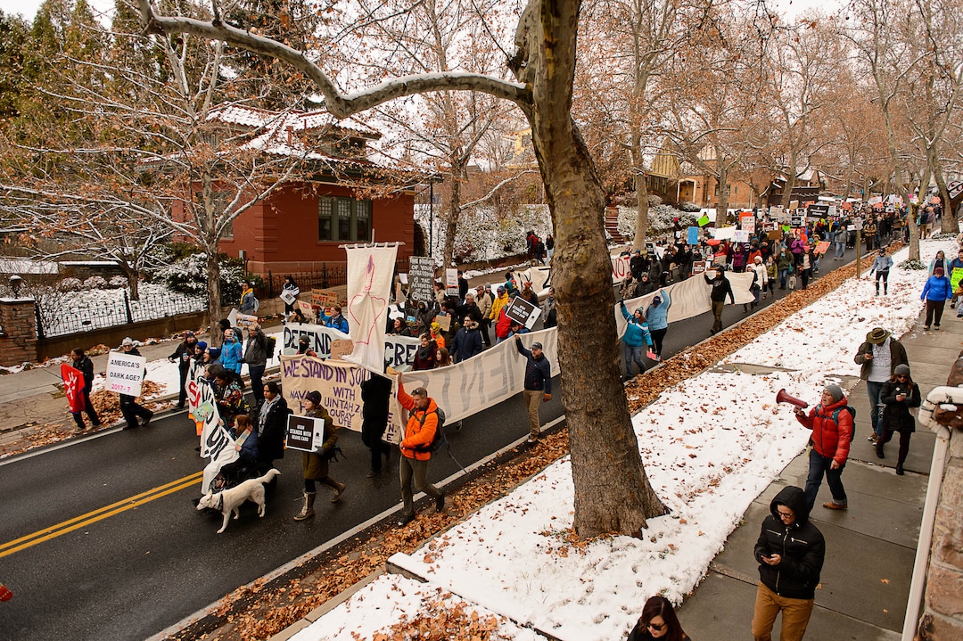 (Trent Nelson | The Salt Lake Tribune)  Protesters march down State Street during rally against a visit by President Donald Trump, Monday December 4, 2017.