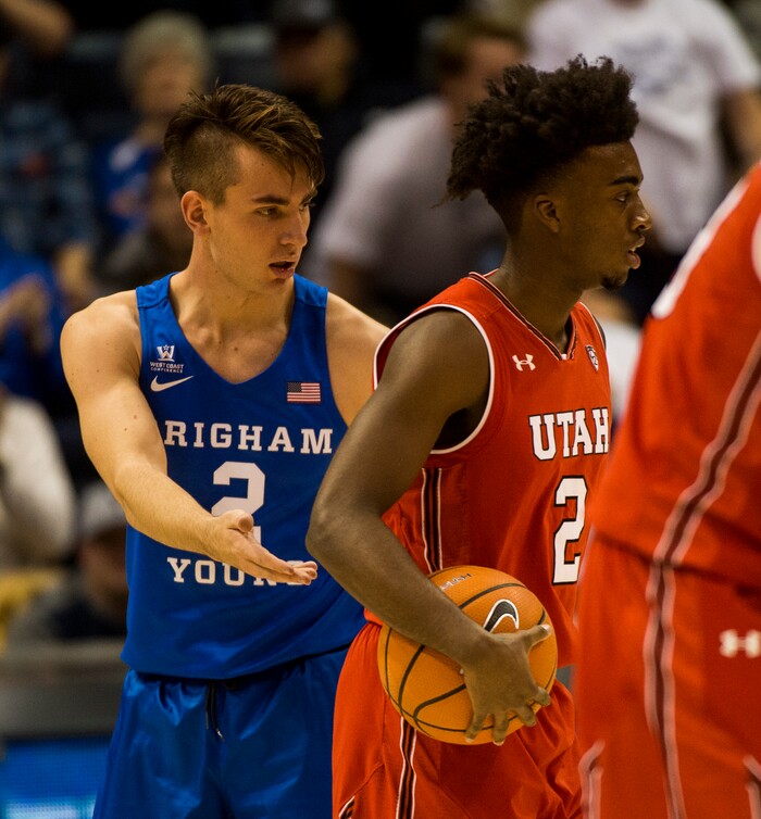(Rick Egan  |  The Salt Lake Tribune)  Utah Utes guard Kolbe Caldwell (2) gets called for a delay of game warning, as he refuses to give the ball to Brigham Young Cougars guard Zac Seljaas (2), in basketball action Utah Utes vs. Brigham Young Cougars at the Marriott Center in Provo, Saturday, December 15, 2017.


