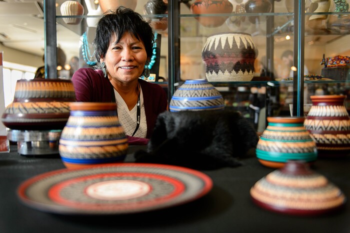 (Trent Nelson | The Salt Lake Tribune)  Navajo artist Cynthia Yazzie with her work at the fifth annual Indian Art Market at the Natural History Museum of Utah in Salt Lake City, Sunday October 15, 2017.