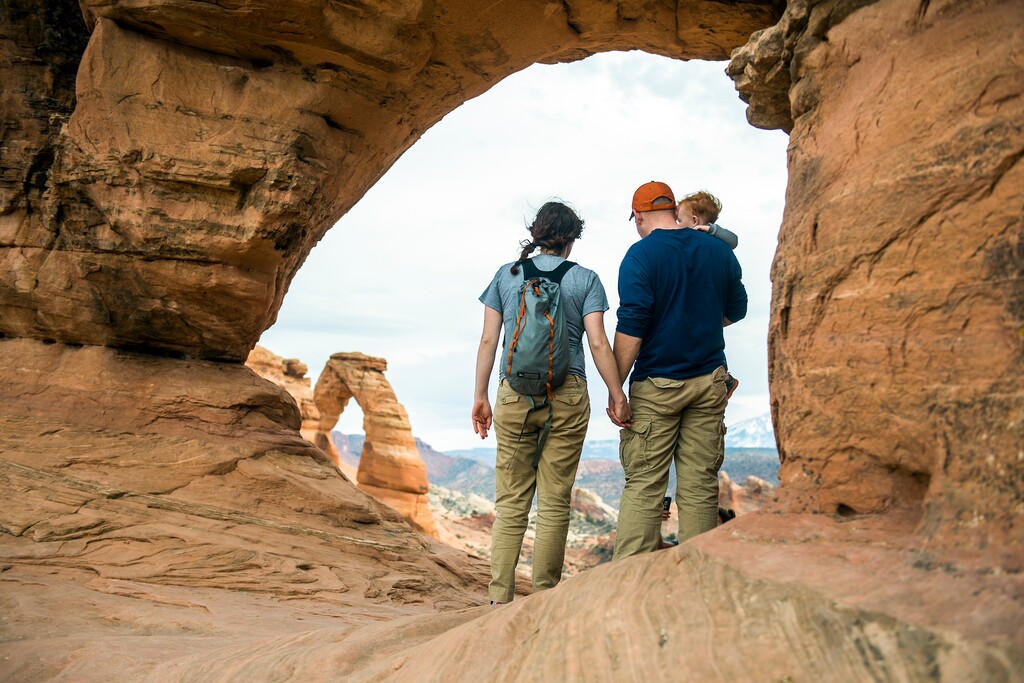 (Chris Detrick  |  Tribune file photo) A family looks at Delicate Arch in Arches National Park Saturday, March 5, 2016.