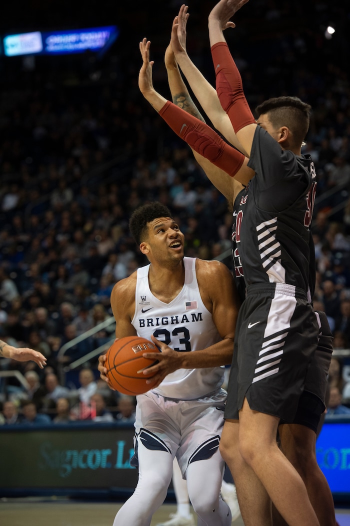 (Rick Egan  |  The Salt Lake Tribune)       Brigham Young Cougars forward Yoeli Childs (23) looks for a shot as he is double teamed by two Santa Clara Broncos, in basketball action between Brigham Young Cougars and Santa Clara Broncos at the Marriott Center in Provo, Saturday, Jan. 12, 2019.


