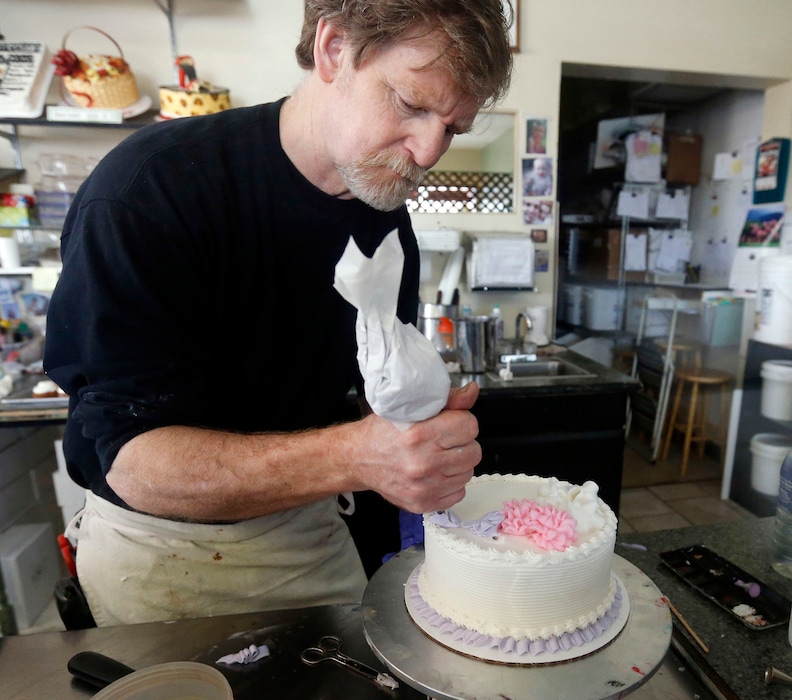 FILE - In this March 10, 2014, file photo, Masterpiece Cakeshop owner Jack Phillips decorates a cake inside his store in Lakewood, Colo.  Prominent chefs, bakers and restaurant owners want the Supreme Court to rule against a Colorado baker who wouldn’t make a cake for a same-sex couple’s wedding. The food makers say that once they open their doors for business, they don’t get to choose their customers.  (AP Photo/Brennan Linsley, File)