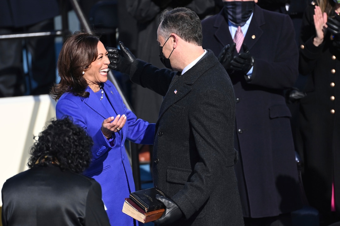 Vice President Kamala Harris reaches to embrace her husband, Doug Emhoff, after being sworn in during the 59th Presidential Inauguration at the U.S. Capitol in Washington, Wednesday, Jan. 20, 2021. (Saul Loeb/Pool Photo via AP)