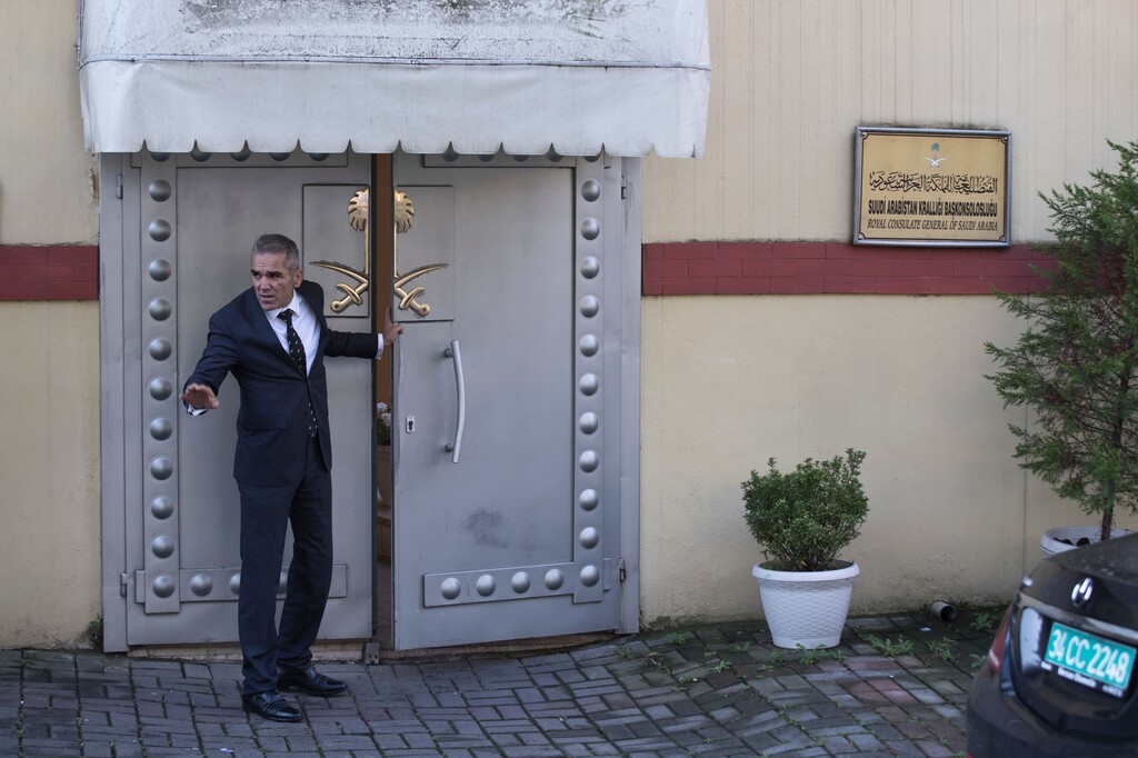 (AP Photo/Petros Giannakouris) A security guard speaks with colleagues at the entrance of Saudi Arabia's consulate in Istanbul, Friday, Oct. 12, 2018. A senior Turkish official says Turkey and Saudi Arabia will form a "joint working group" to look into the disappearance of Saudi writer Jamal Khashoggi.