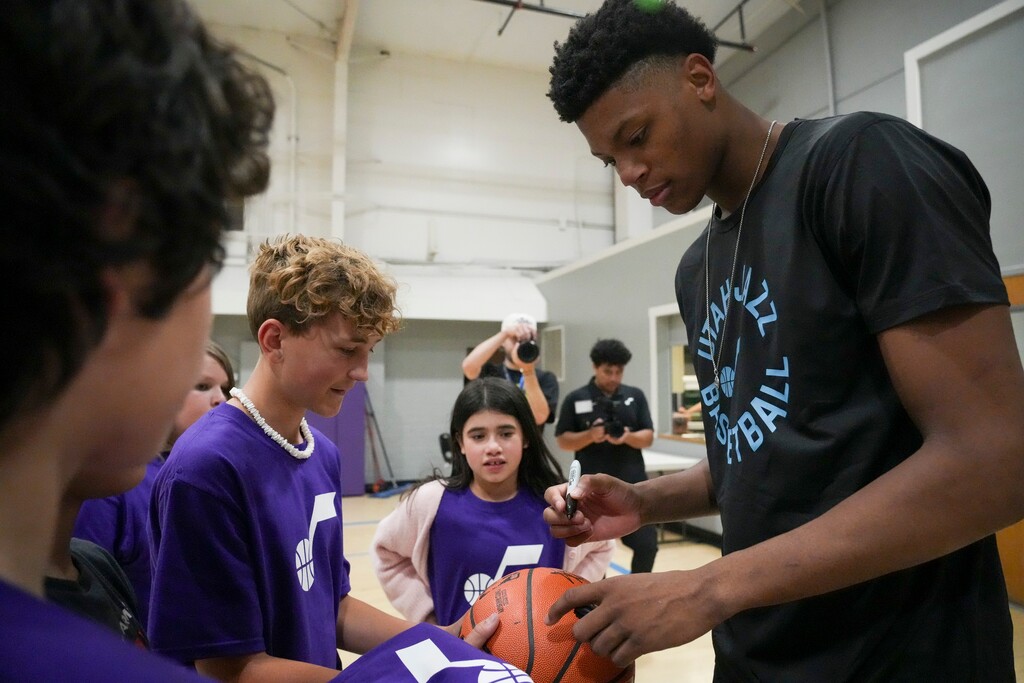 (Bethany Baker | The Salt Lake Tribune) Utah Jazz rookie Ace Bailey signs a basketball during a basketball clinic with new Utah Jazz rookies at the Boys and Girls Club of Greater Salt Lake in Murray on Tuesday, July 1, 2025.