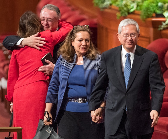 (Rick Egan  |  The Salt Lake Tribune)          Newly called Apostles Elder Ulisses Soares hugs his wife, Sister Rosana Soares, as Elder Gerrit W. Gong and his wife, Sister Susan Gong, leave the stand, after the Saturday morning session of the188th Annual General Conference in Salt Lake City,  Saturday, March 31, 2018.