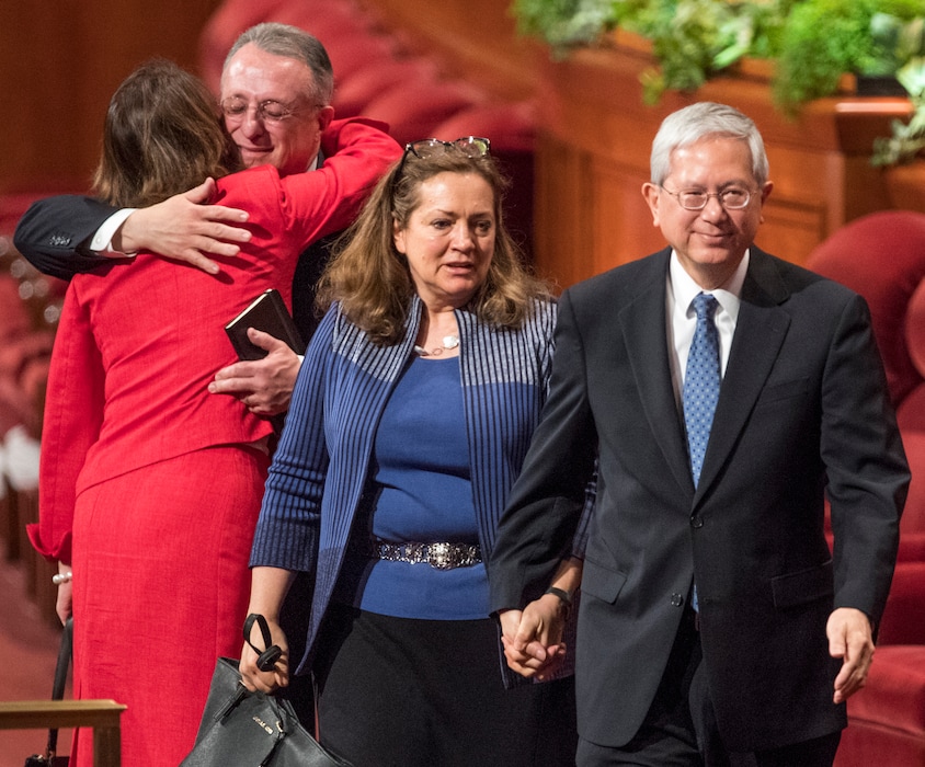 (Rick Egan  |  Tribune file photo) 
In March 2018, then newly called apostle Gerrit W. Gong and his wife, Susan, leave the stand at General Conference. In the back, another newly named apostle, Ulisses Soares, hugs his wife, Rosana.
