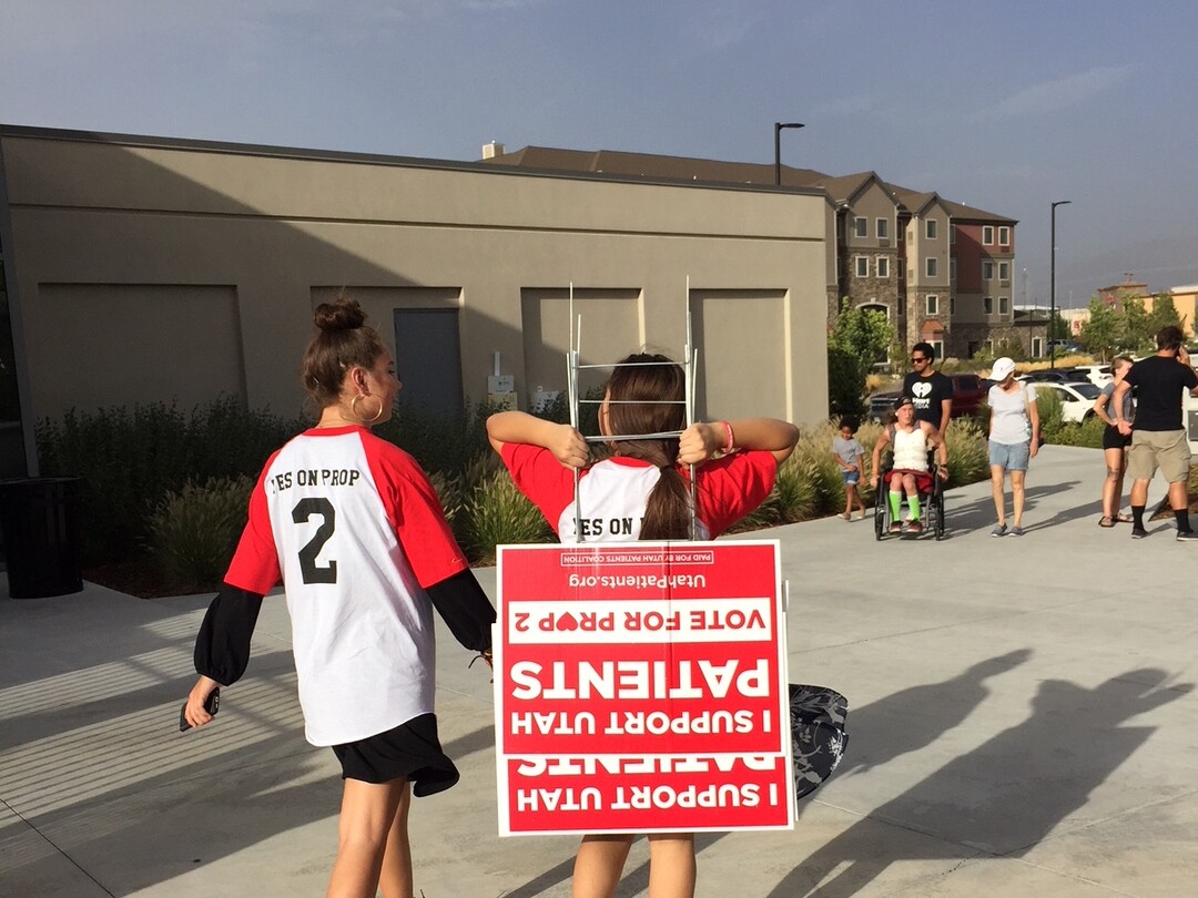 (The Salt Lake Tribune | Kathy Stephenson) Supporters of Proposition 2 picked lawn signs during a Saturday rally.