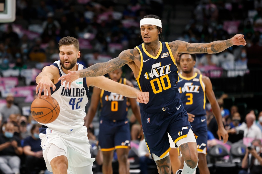 Dallas Mavericks forward Maxi Kleber (42) and Utah Jazz guard Jordan Clarkson (00) compete for control of the ball during the first half of a preseason NBA basketball game in Dallas, Wednesday, Oct. 6, 2021. (AP Photo/Michael Ainsworth)