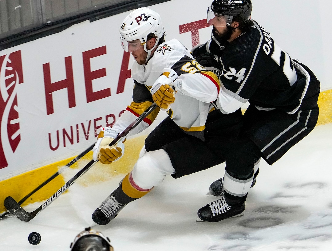 (Leah Hogsten | The Salt Lake Tribune) Vegas Golden Knights defenseman Dylan Coghlan (52) and Los Angeles Kings left wing Phillip Danault (24) battle for possession as the Los Angeles Kings and Vegas Knights meet in a preseason game at Vivint Arena on Sept. 30, 2021.