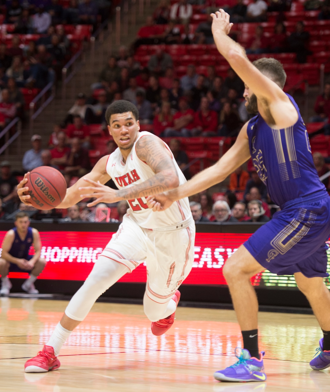(Rick Egan  |  The Salt Lake Tribune)       College of Idaho forward, Matt Myers defends, as Utah guard Utah Utes forward Timmy Allen (20) drives to the hoop, in basketball action, between the Utah Utes and the College of Idaho Yotes at the Jon M. Huntsman Center, Thursday, Nov. 1, 2018.