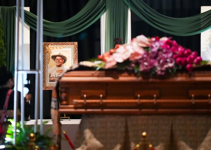 (Bethany Baker  |  The Salt Lake Tribune) A photo of Afa Ah Loo, the man shot and killed during the 'No Kings' protest, is seen behind the casket during the celebration of life at the Salt Palace Convention Center in Salt Lake City on Friday, June 27, 2025.