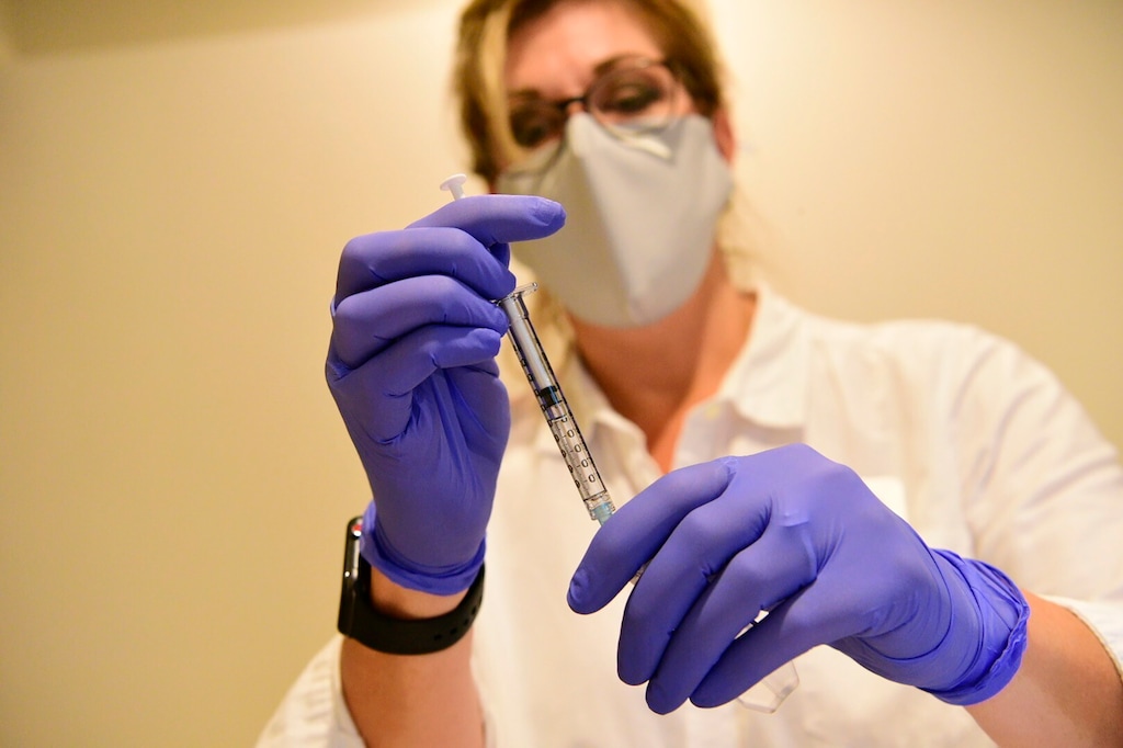 This Sept. 2020 photo provided by Johnson & Johnson shows a clinician preparing to administer investigational Janssen COVID-19 vaccine. Johnson & Johnson's long-awaited COVID-19 vaccine appears to protect against symptomatic illness with just one shot – not as strong as some two-shot rivals but still potentially helpful for a world in dire need of more doses. Johnson & Johnson said Friday, Jan. 29, 2021 that in the U.S. and seven other countries, the first single-shot vaccine appears 66% effective overall at preventing moderate to severe COVID-19. It was more protective against severe symptoms, 85%. (Johnson & Johnson via AP)