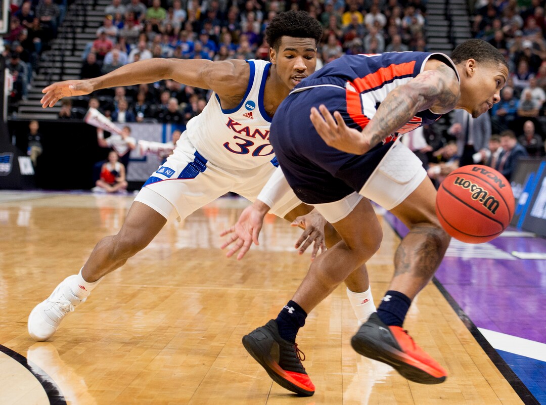 (Leah Hogsten  | The Salt Lake Tribune)  Kansas Jayhawks guard Ochai Agbaji (30) pressures Auburn Tigers guard J'Von McCormick (12) as Auburn faces Kansas in the second round of the NCAA tournament in Salt Lake City on Saturday, March 23, 2019.