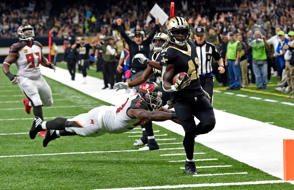 New Orleans Saints running back Alvin Kamara (41) carries for a touchdown past a diving Tampa Bay Buccaneers defensive tackle Clinton McDonald in the first half of an NFL football game in New Orleans, Sunday, Nov. 5, 2017. (AP Photo/Bill Feig)