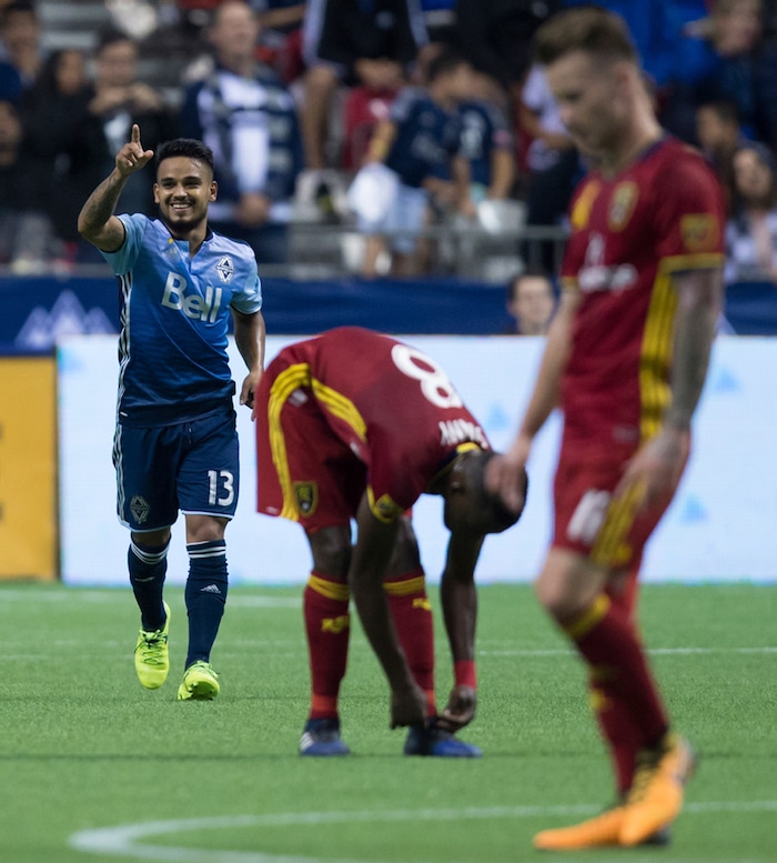 Vancouver Whitecaps' Cristian Techera, back left, celebrates after scoring a goal as Real Salt Lake's Stephen Sunday (8) ties his shoe and Albert Rusnak pauses during the first half of an MLS soccer match Saturday, Sept. 9, 2017, in Vancouver, British Columbia. (Darryl Dyck/The Canadian Press via AP)