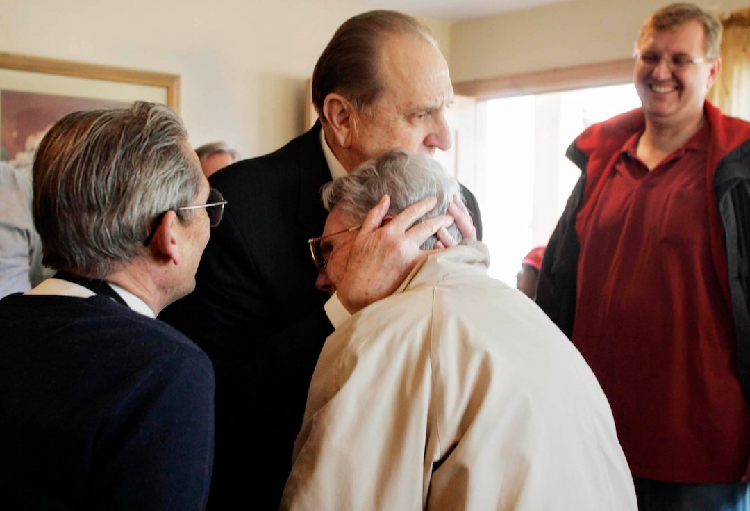 (Tribune file photo) President Thomas S. Monson embraces Adele Putnam after her familyÕs home was renovated as part of the Gingerbread House Project in 2005.