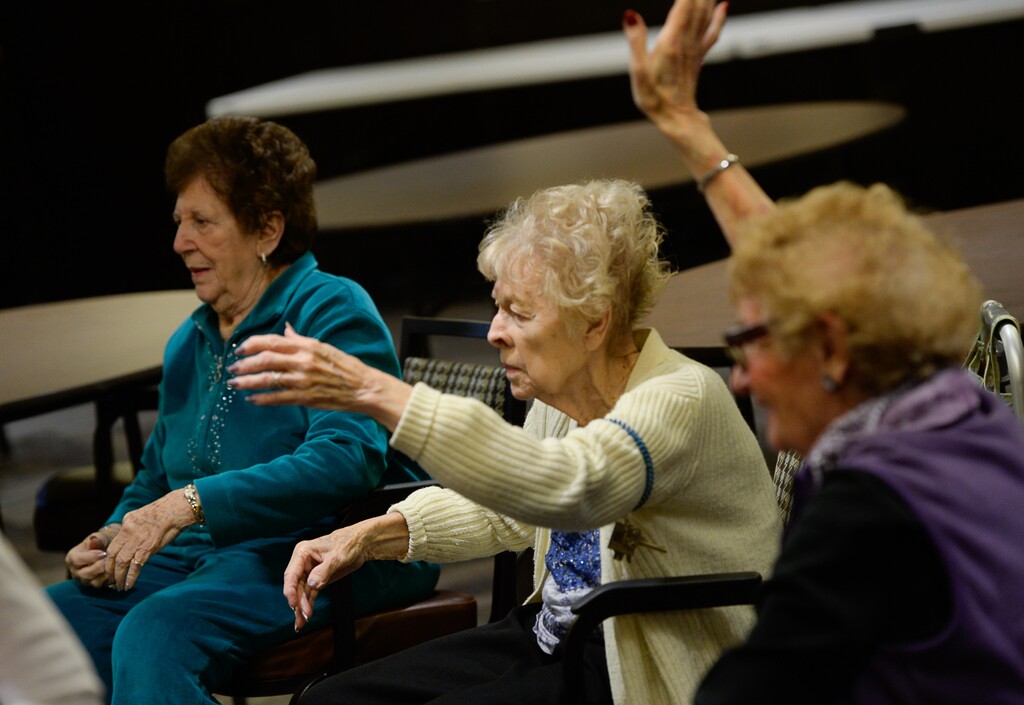 (Francisco Kjolseth  |  The Salt Lake Tribune)  Full of joyful energy, Juan Carlos Claudio brings his Minding Motion dance workshop to residents at Cottonwood Place Senior Living in Holladay. Leading residents through a series of movements to music they can relate to, participants feel the joy expressed and feel purposeful despite their particular mobility.
