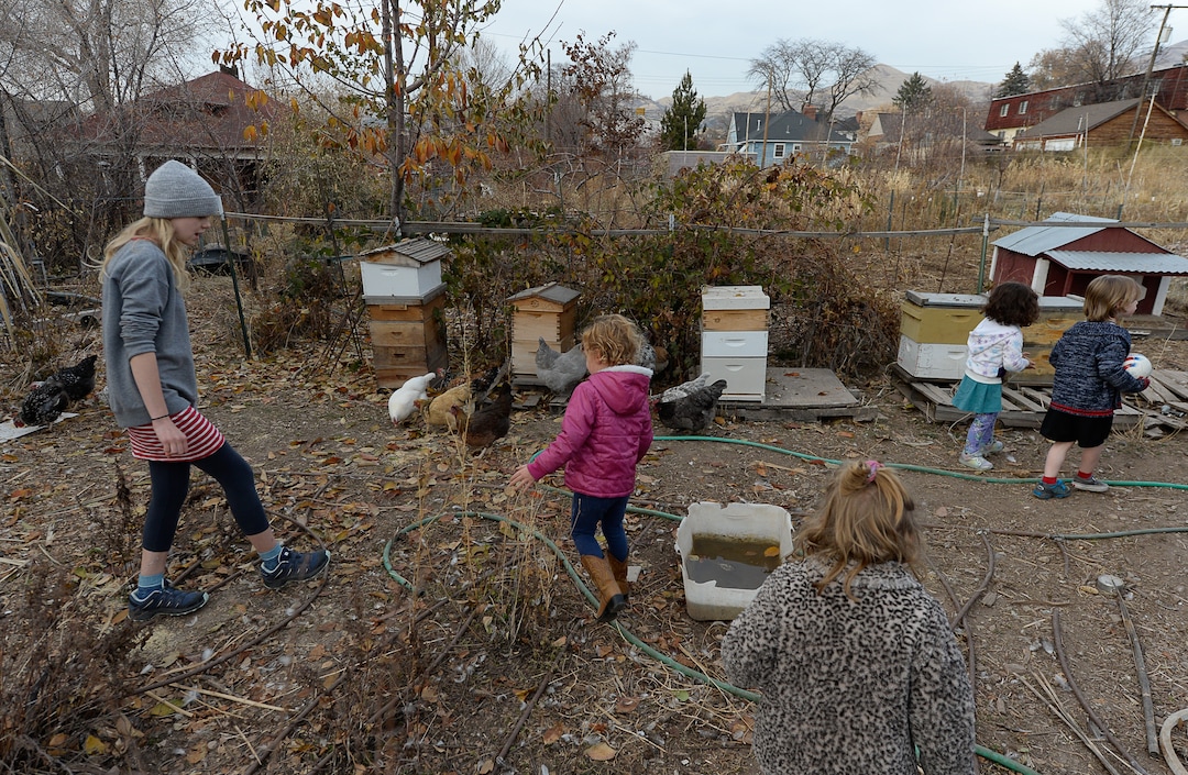 (Francisco Kjolseth  |  The Salt Lake Tribune)  Zoey Porucznik, 13, gives young kids from the neighborhood a look around the community garden that has been next to her home at the end of Elizabeth Street in Salt Lake City on Tuesday, Oct. 19, 2019. The Poruczniks grow on one of the 42 plots at the garden, which has operated on church land for 43 years.