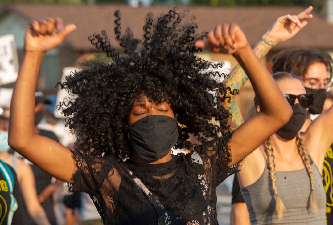(Rick Egan  |  The Salt Lake Tribune)      Kayla McKay dances to the music as the protesters march through Rose Park, during the Dance Dance for Revolution protest for racial equality, on Sunday, Aug. 23, 2020. The protest was in memory of Jovany Mercardo who was shot last August by Ogden police by four officers, hitting his body sixteen times.